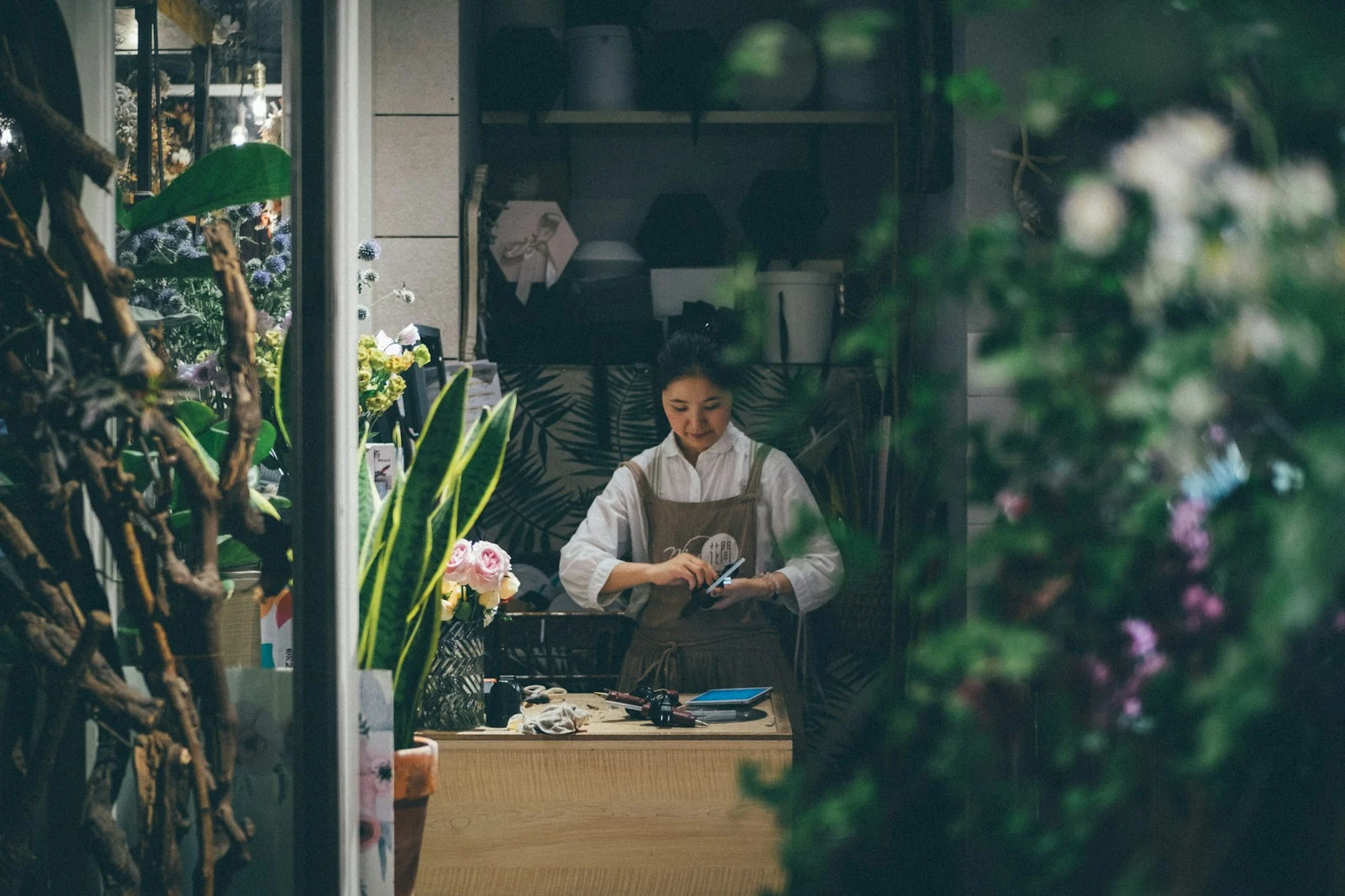 TNS : woman standing beside the table
