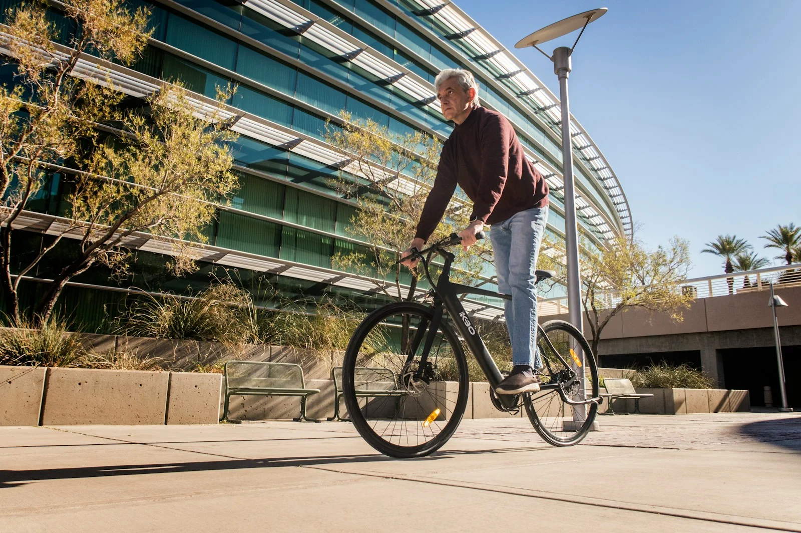 Mutuelle Sante Senior : man in red long sleeve shirt and blue denim jeans riding on bicycle