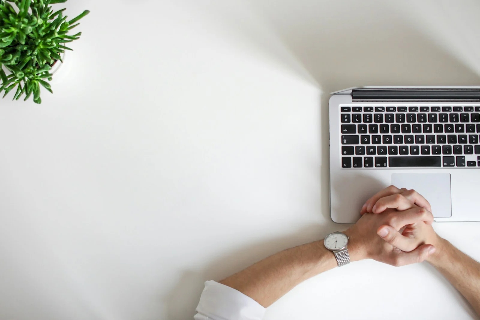 TNS : person wearing watch near laptop