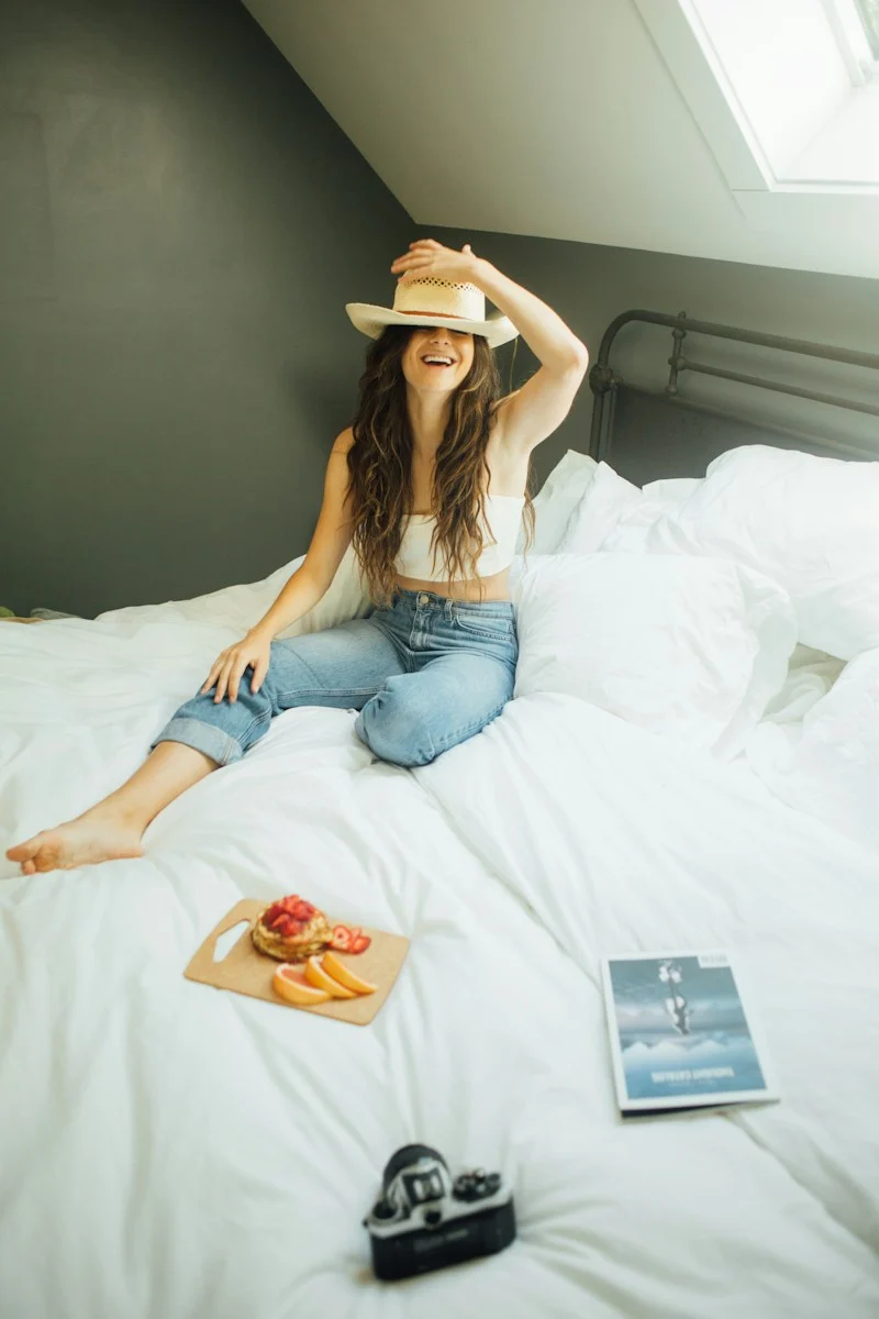Mutuelle Individuelle : woman sitting on bed holding her hat