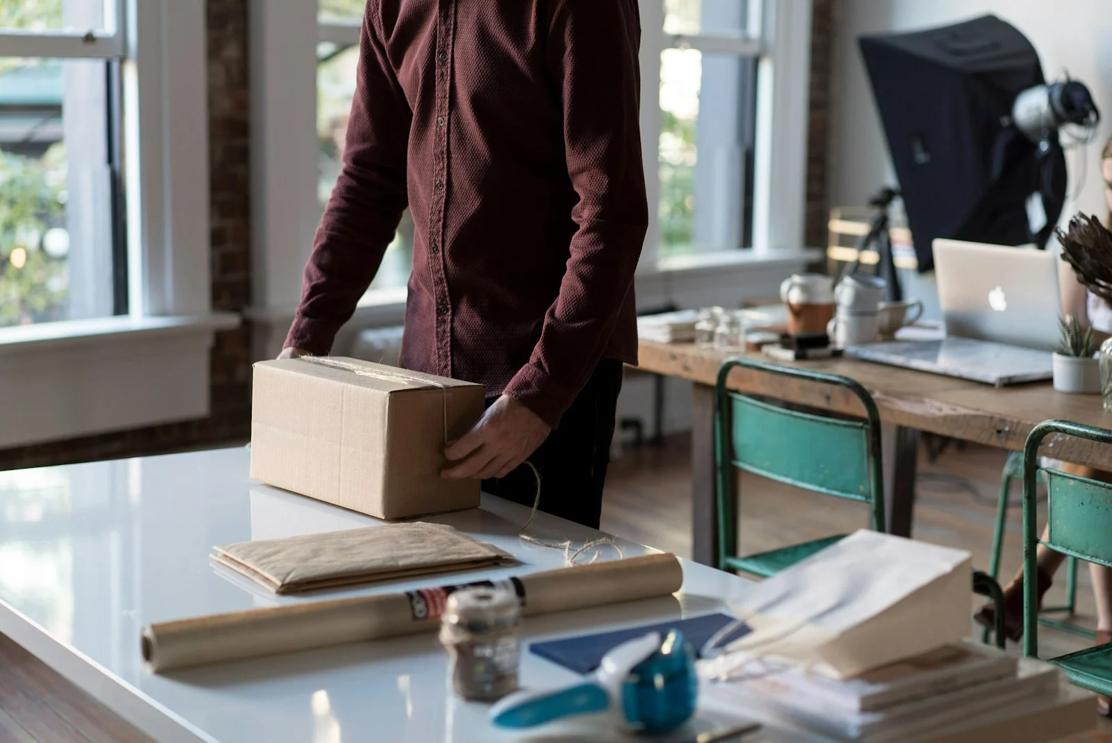 TNS : person holding cardboard box on table
