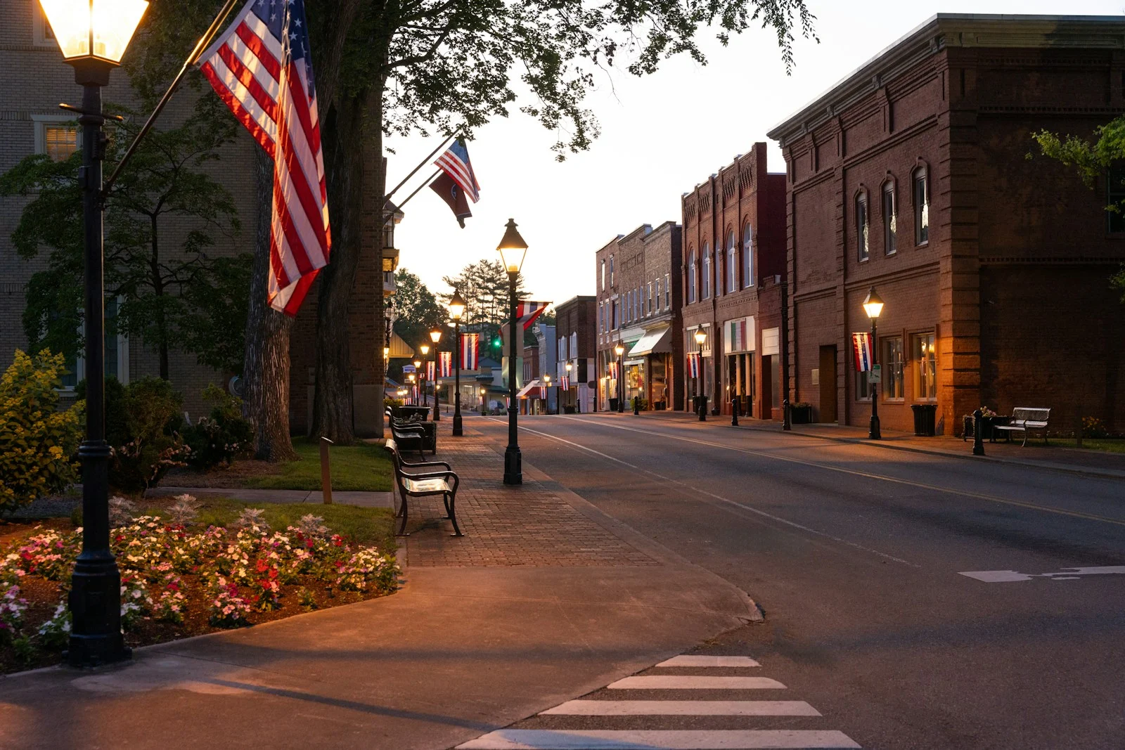 TNS : Small town street at dusk with american flags