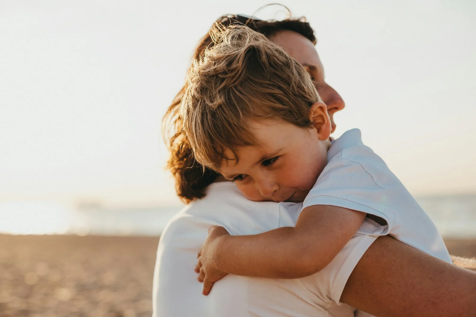 Family boy hugging woman during daytime