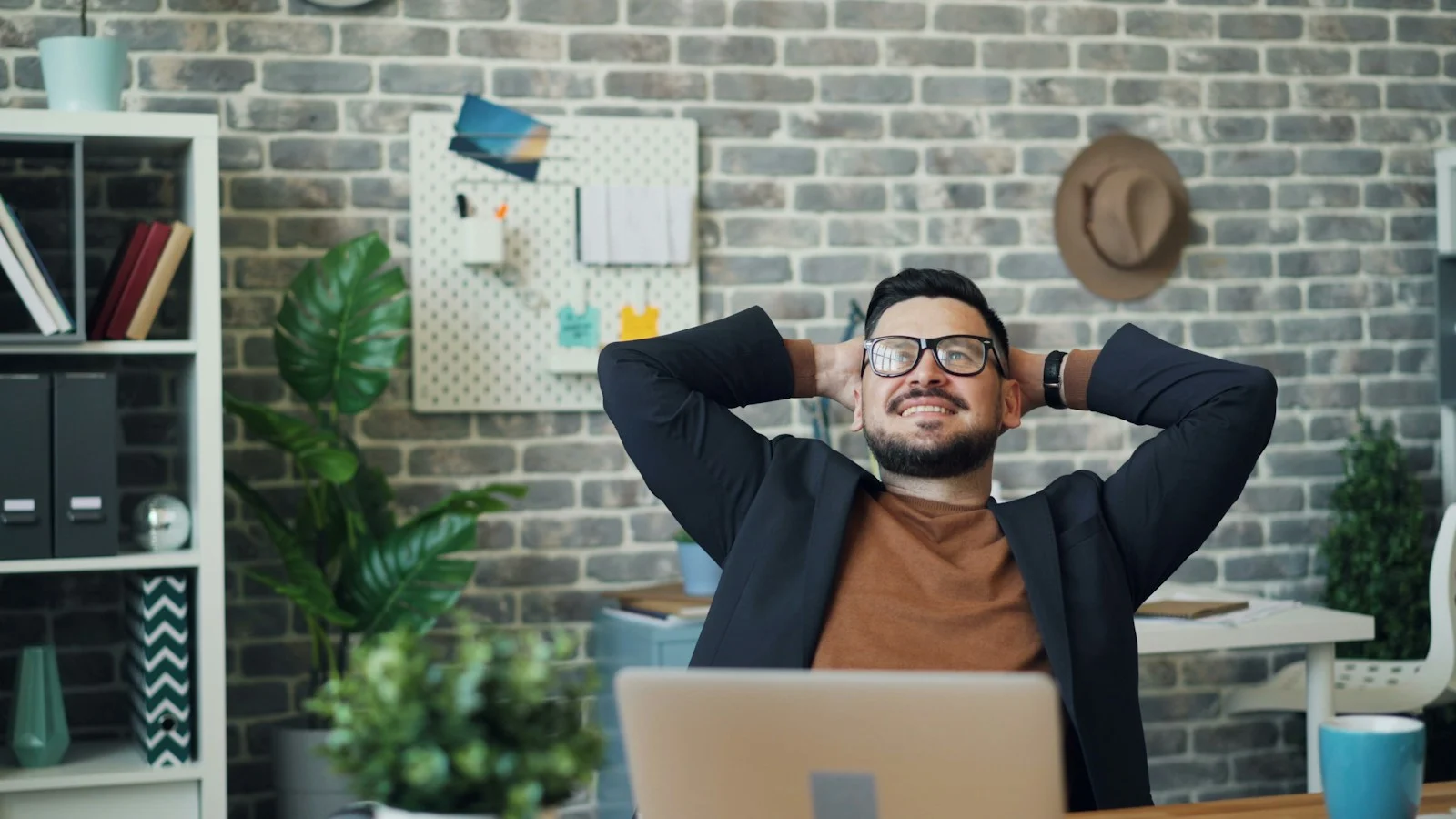 Mutuelle Individuelle : a man sitting at a desk with his hands behind his head