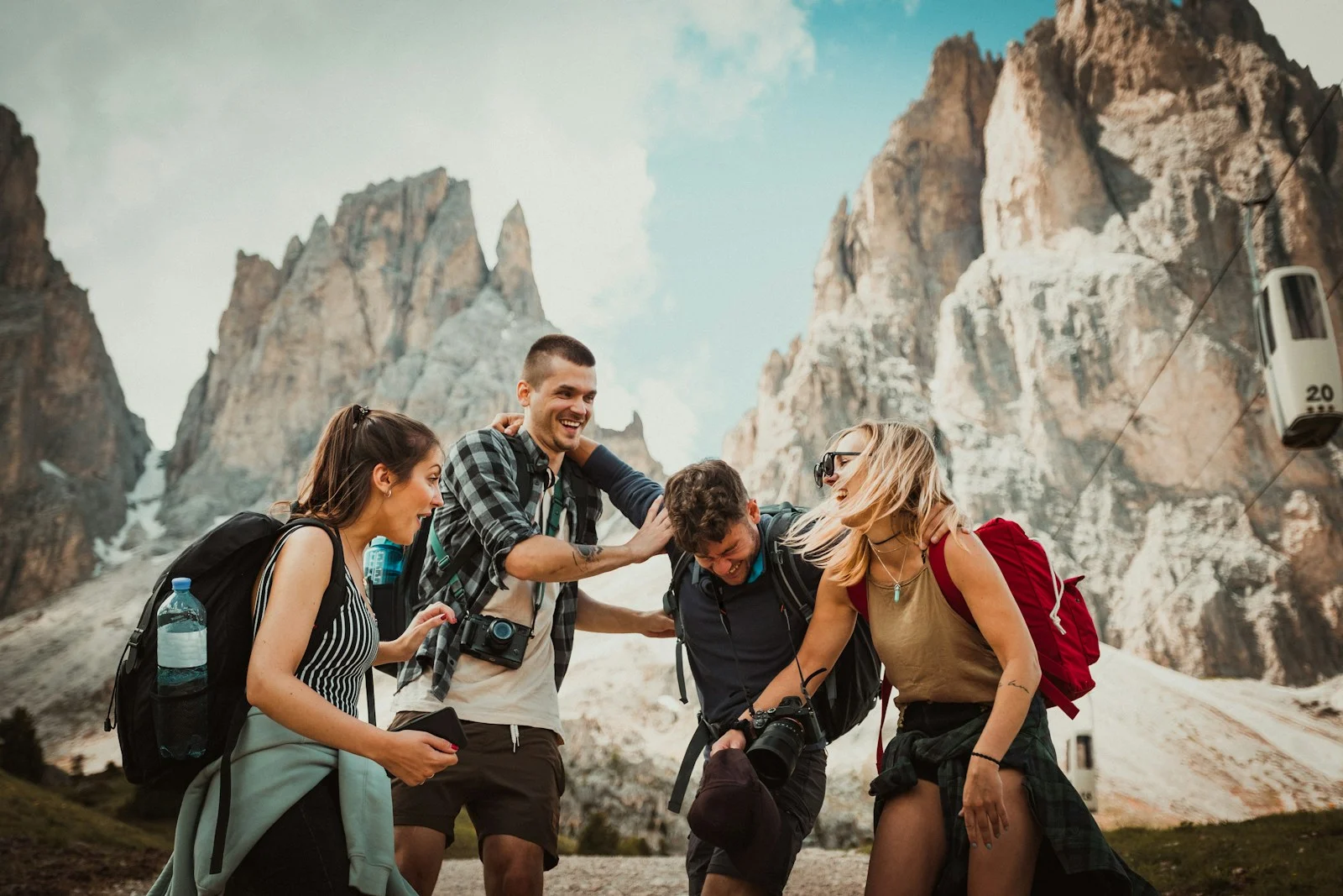 Expatrie : low-angle photography of two men playing beside two women