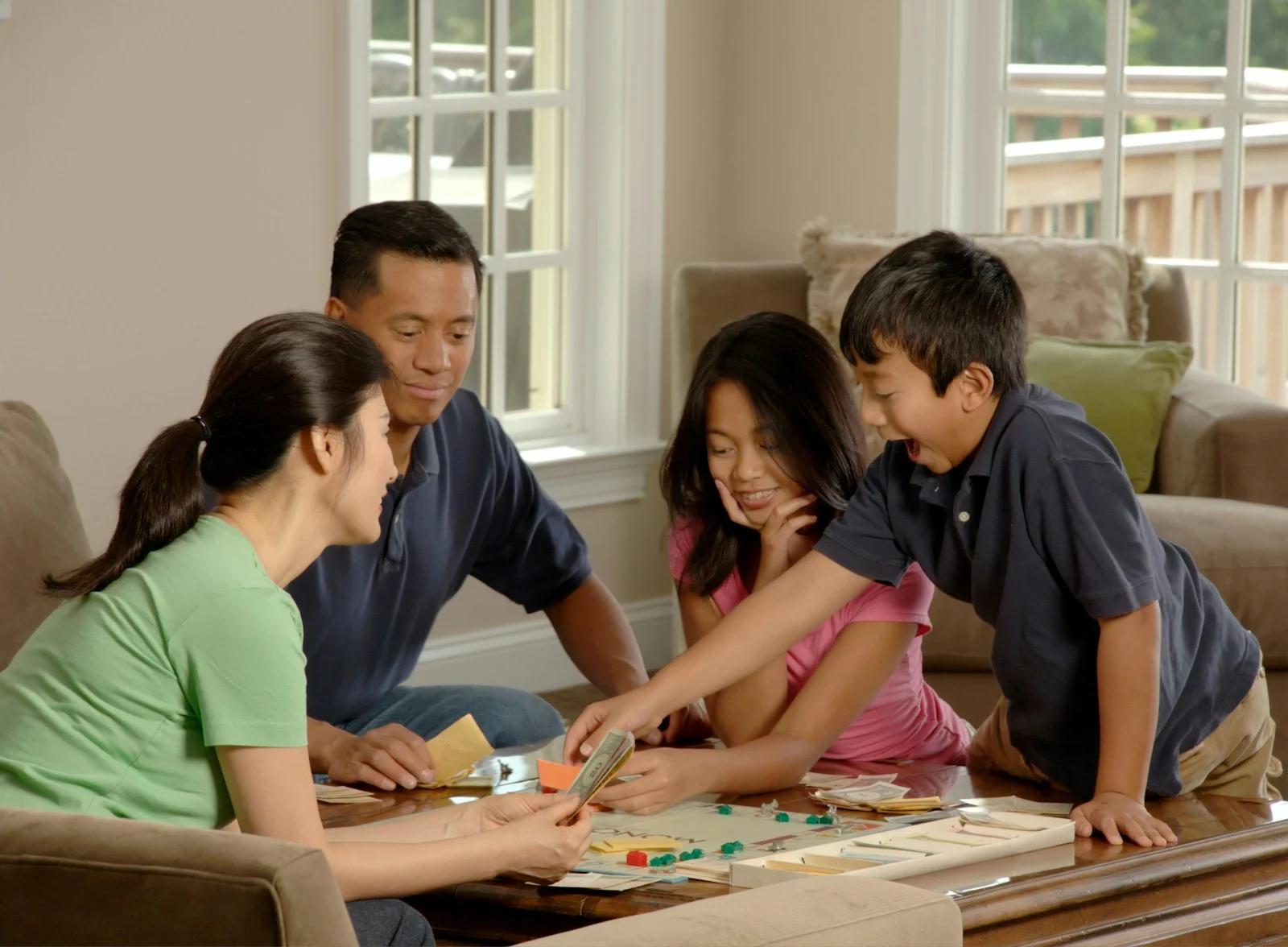 Family group of people beside coffee table