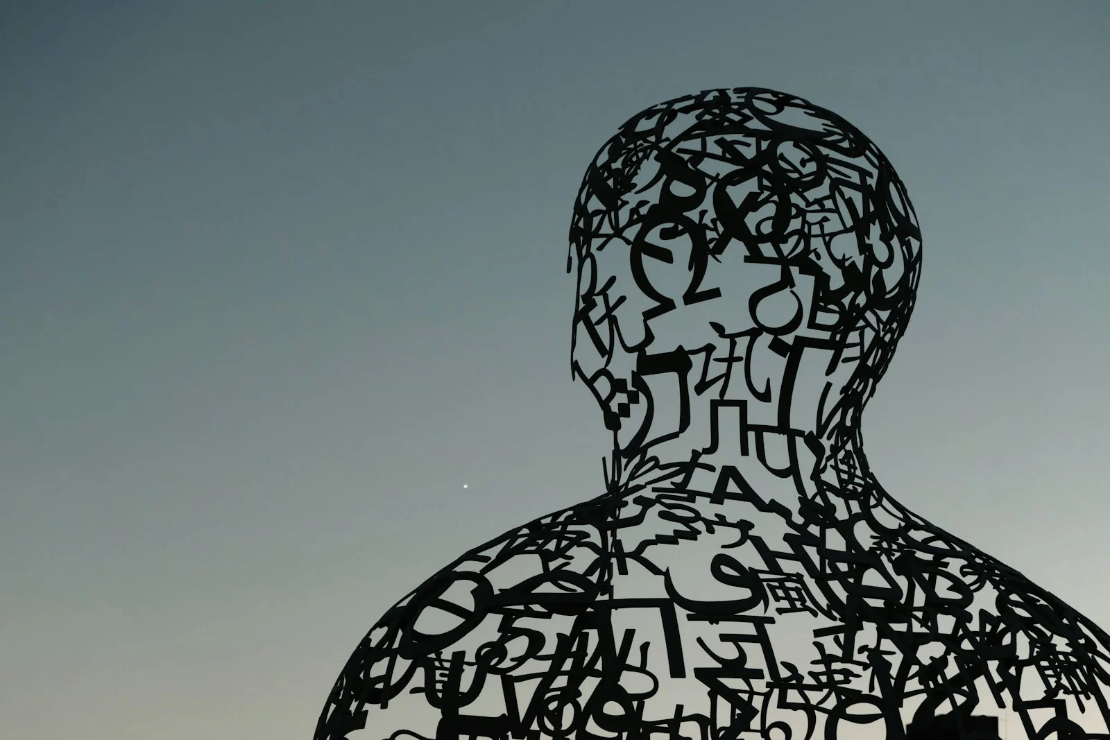 mutuelle santé : a sculpture of a man with letters all over it